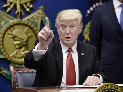 President Donald Trump signs executive orders in the Hall of Heroes at the Department of Defense on January 27, 2017 in Arlington, Virginia.


